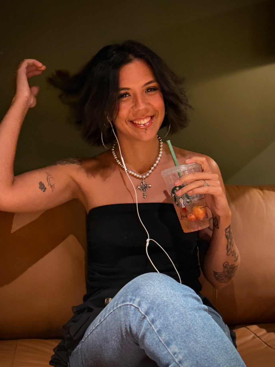 Anna Clara sentada no sofá, sorrindo